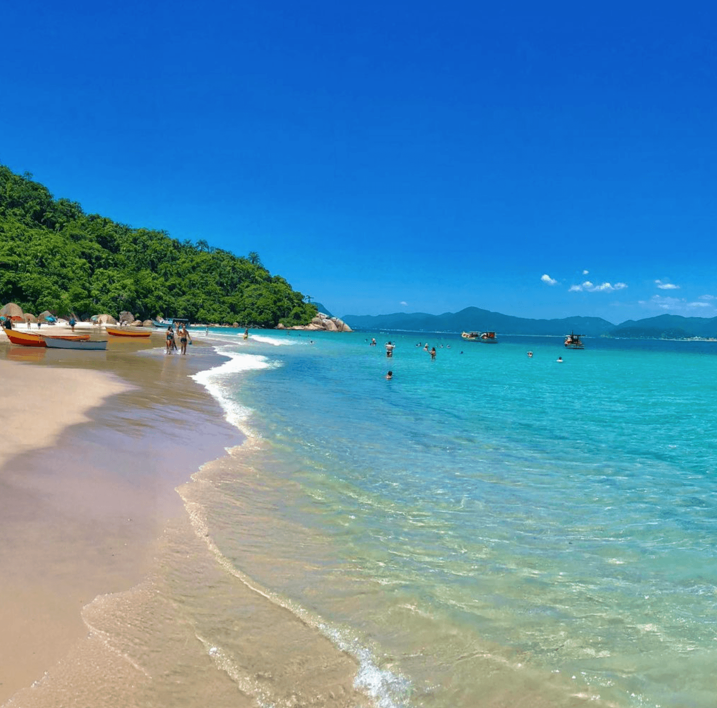 Ilha do Campeche com águas cristalinas e barcos em Florianópolis SC